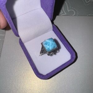 Larimar stone on 925 silver setting

Size 9